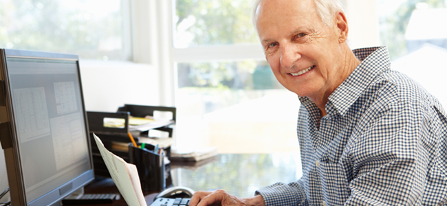 Senior man working on computer at home